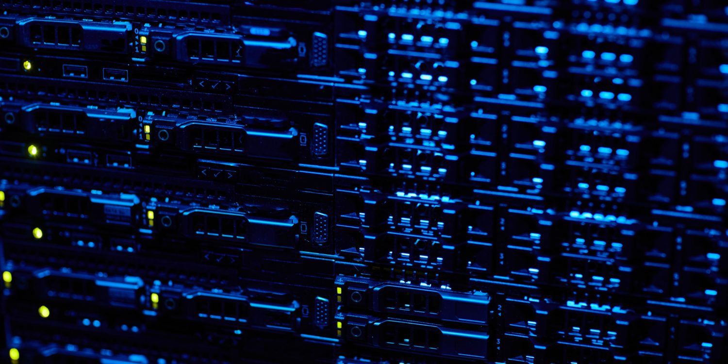 A close up of a server rack in a dark room.