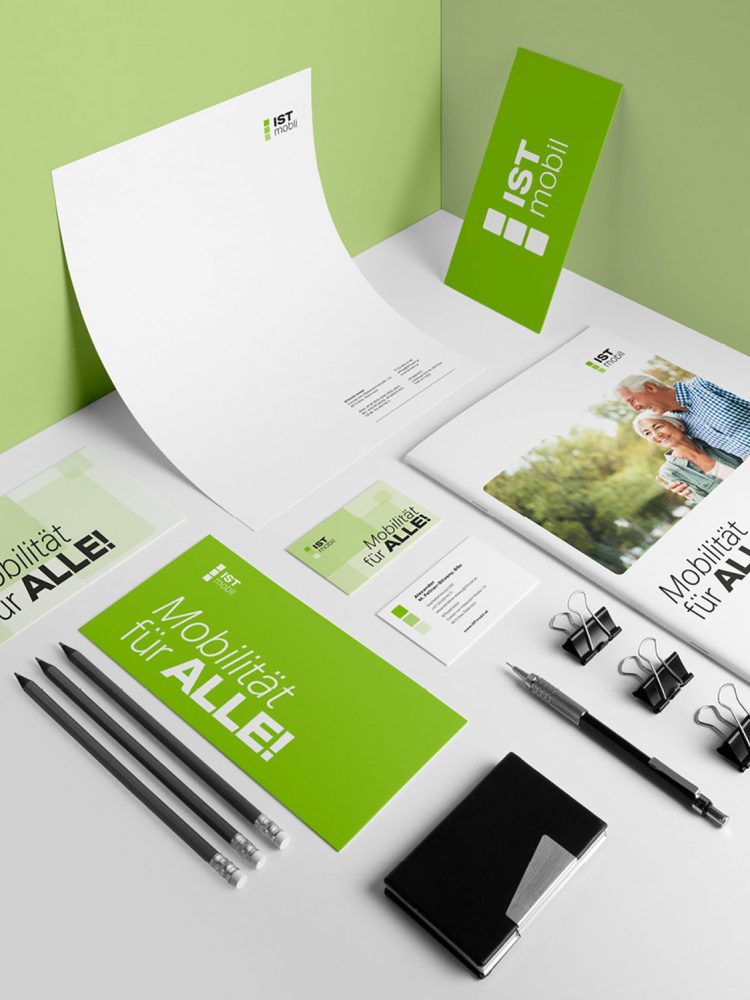 A green business stationery set on a table, featuring ISTmobil branding.