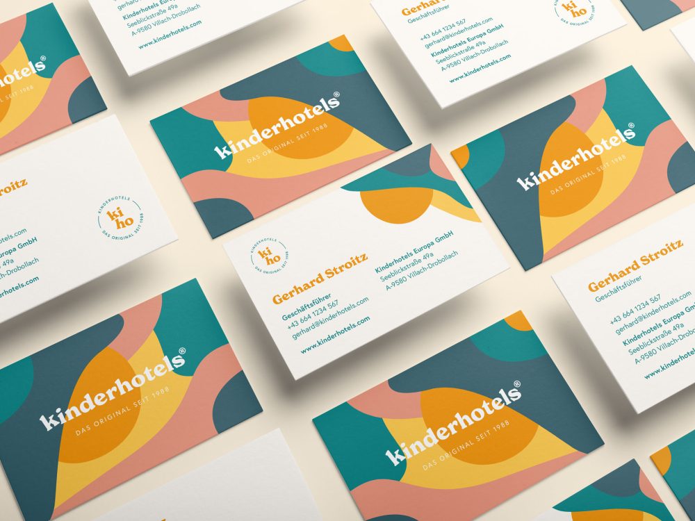 A set of Kinderhotels business cards with different shapes and colors.