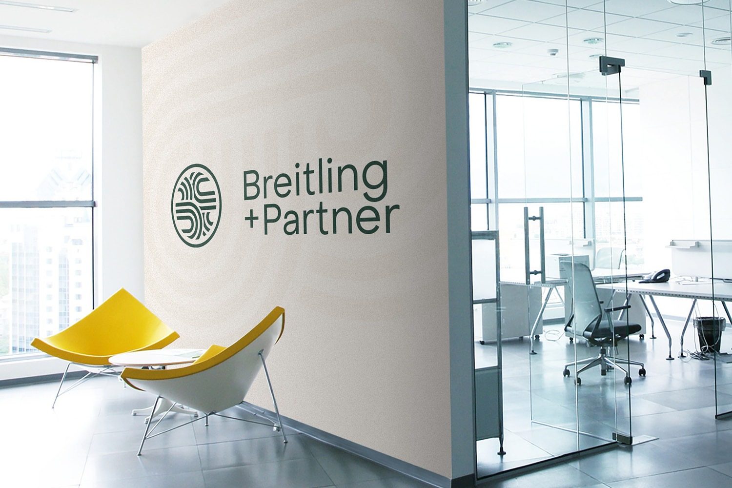 An office with a yellow chair and a sign that says Breitling Partner.