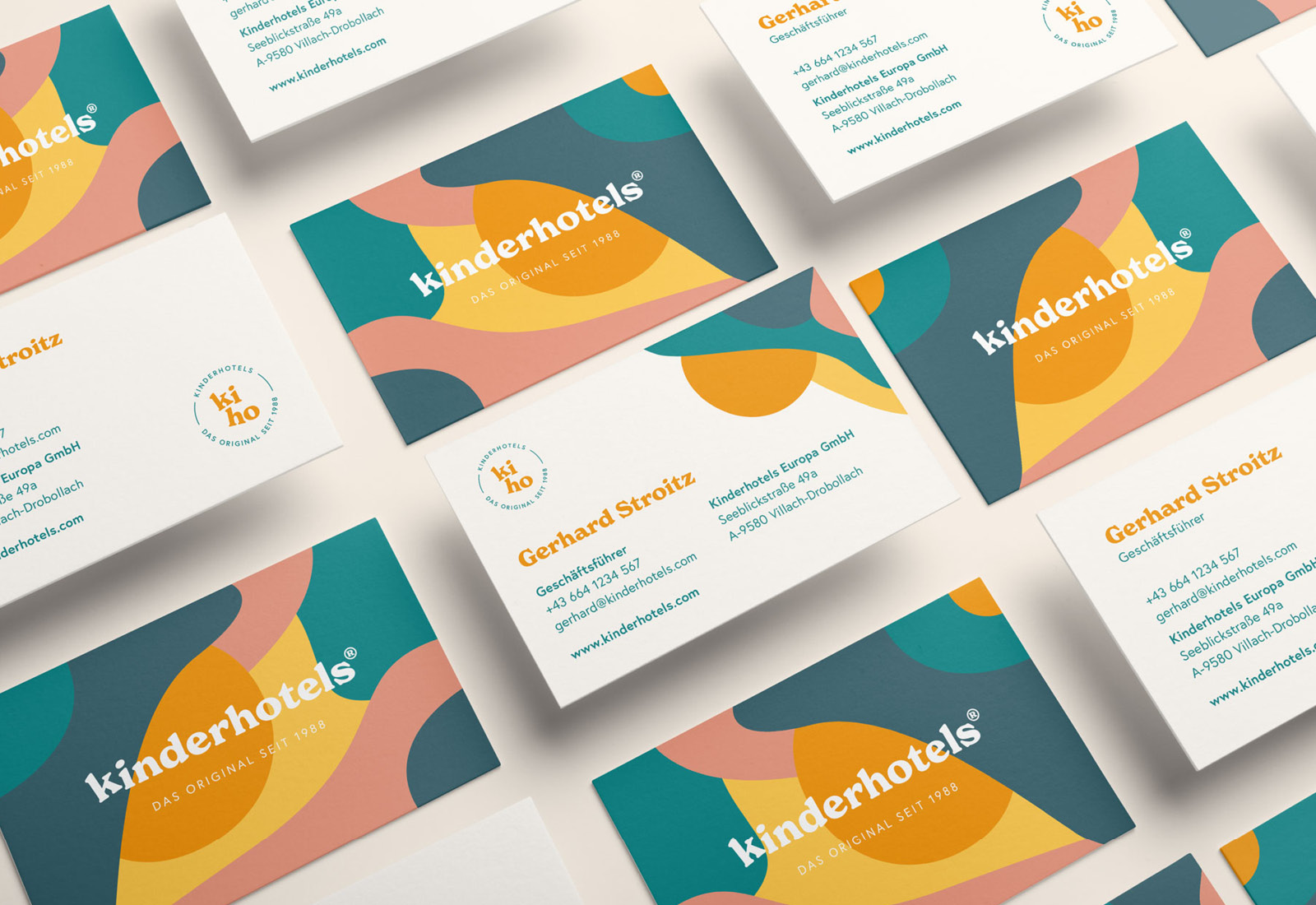 A set of Kinderhotels business cards with colorful designs.