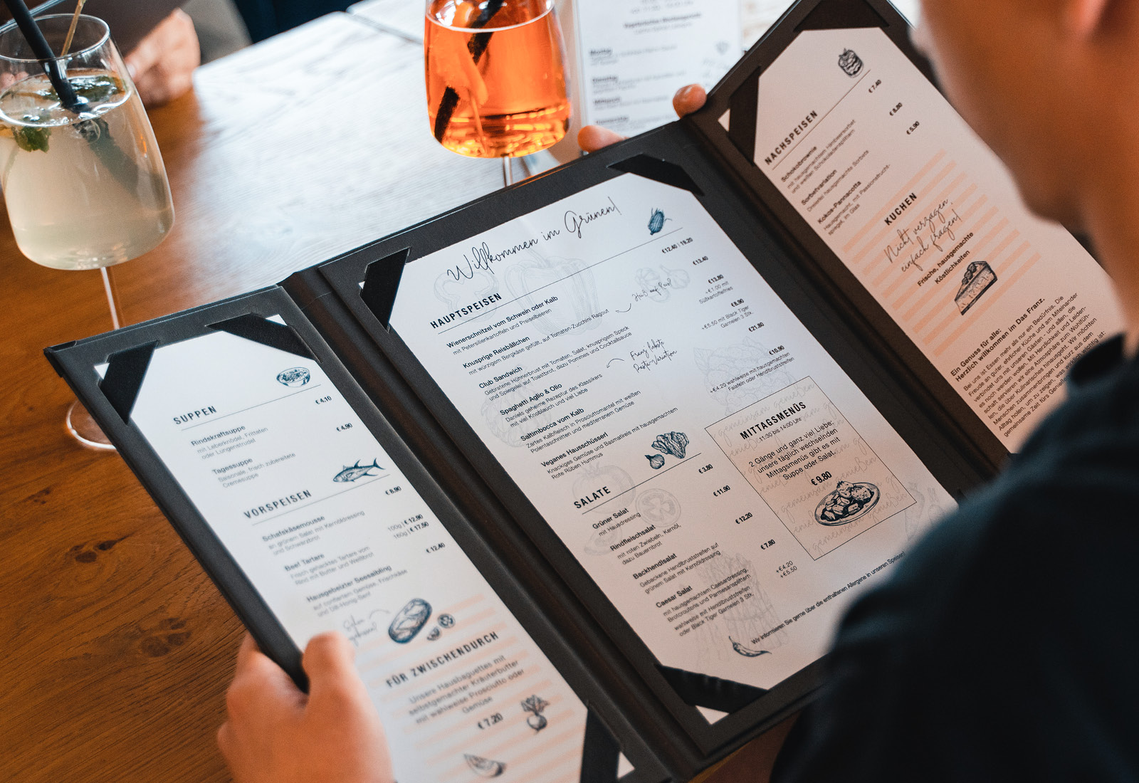 A person looking at a menu at a restaurant.