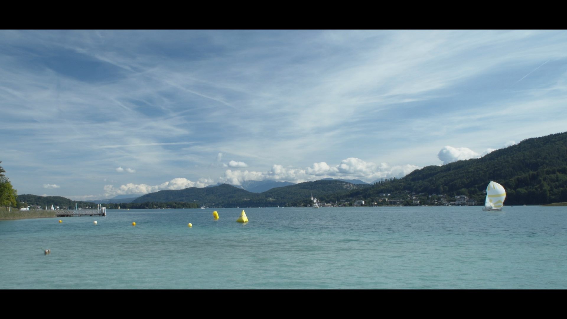 A group of sailboats in a body of water at Austria Swim Open.