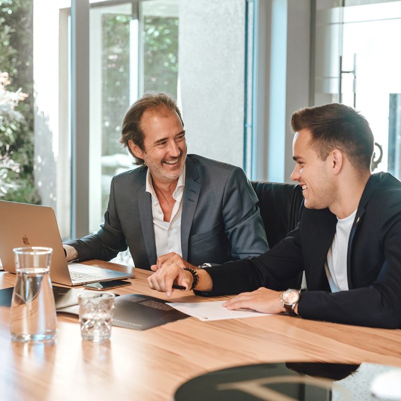 Two Valere businessmen sitting at a conference table.