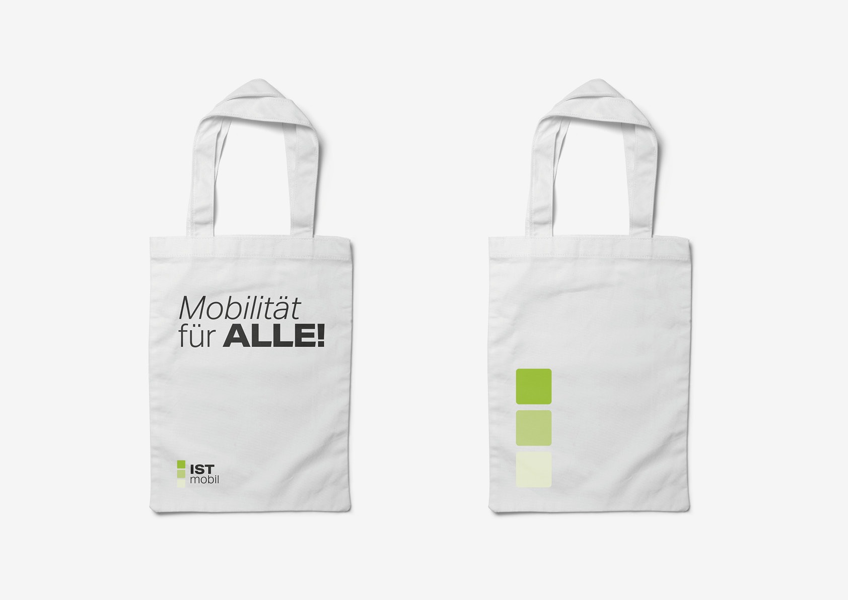 A white tote bag with a green ISTmobil logo.