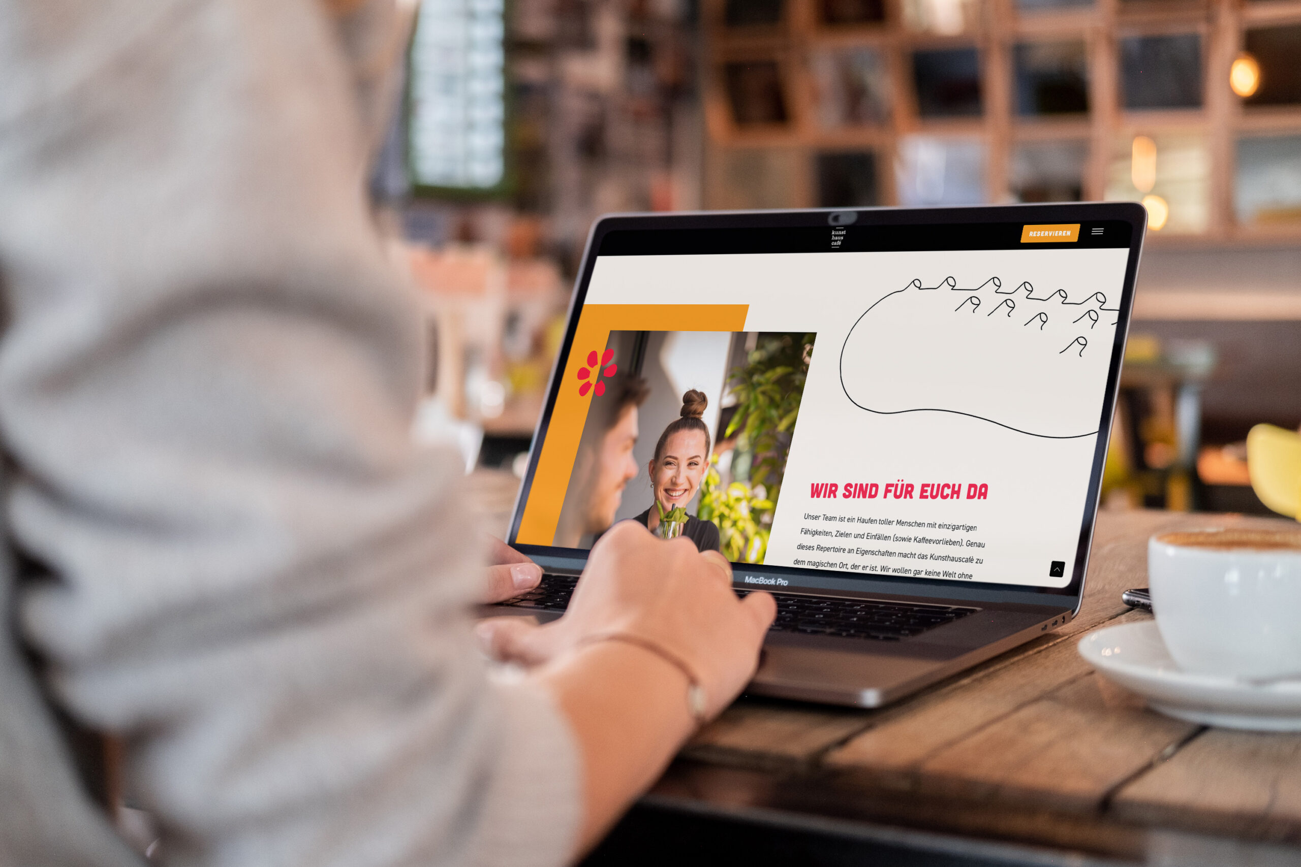 A woman in Graz is using a laptop for website design at an agency.