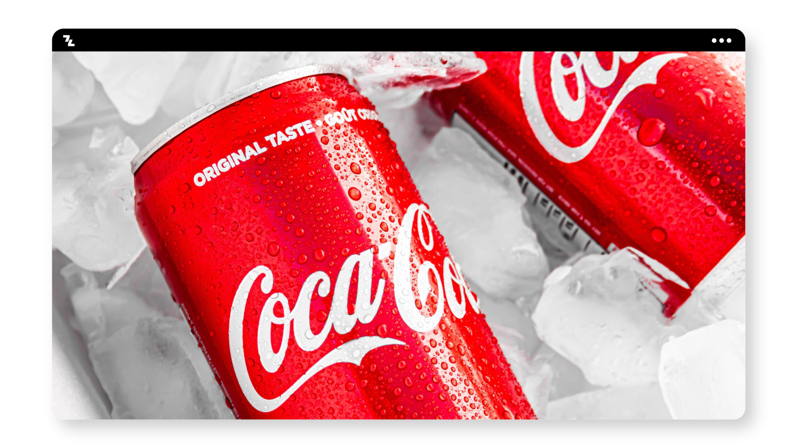 Two cans of Coca Cola sitting on ice, protected from melting.