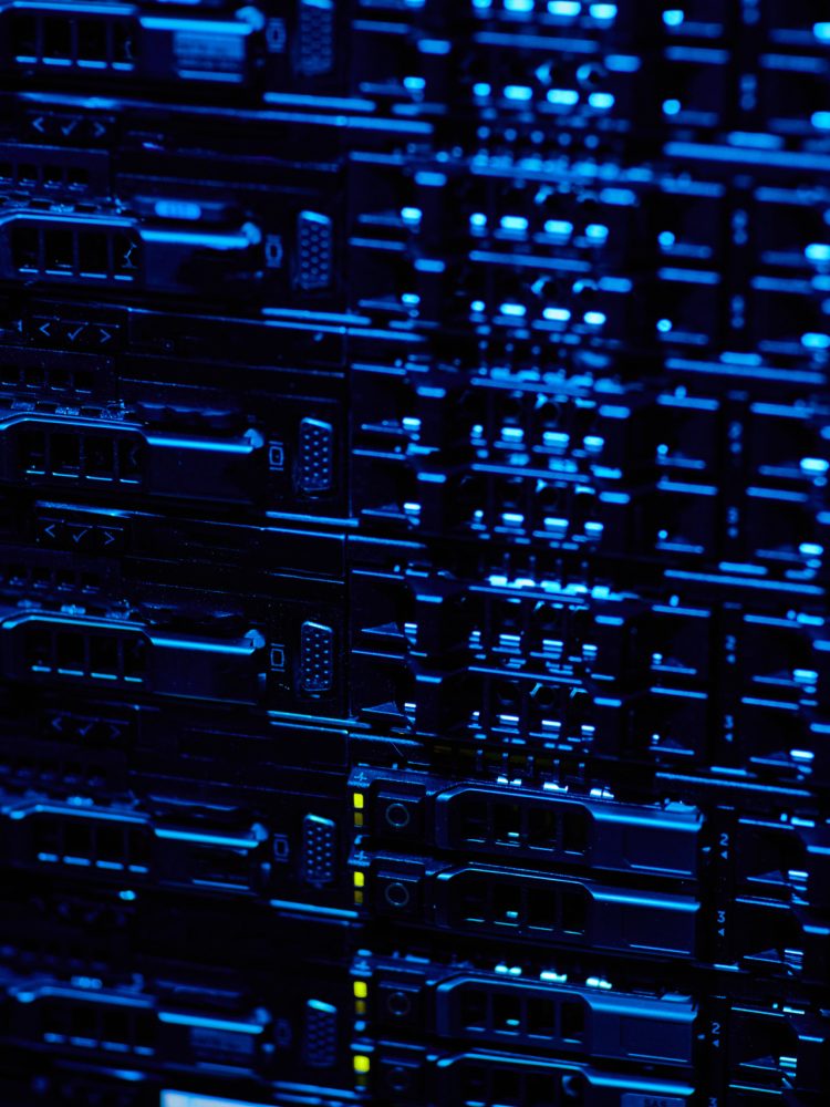 A close up of a server rack in a dark room.