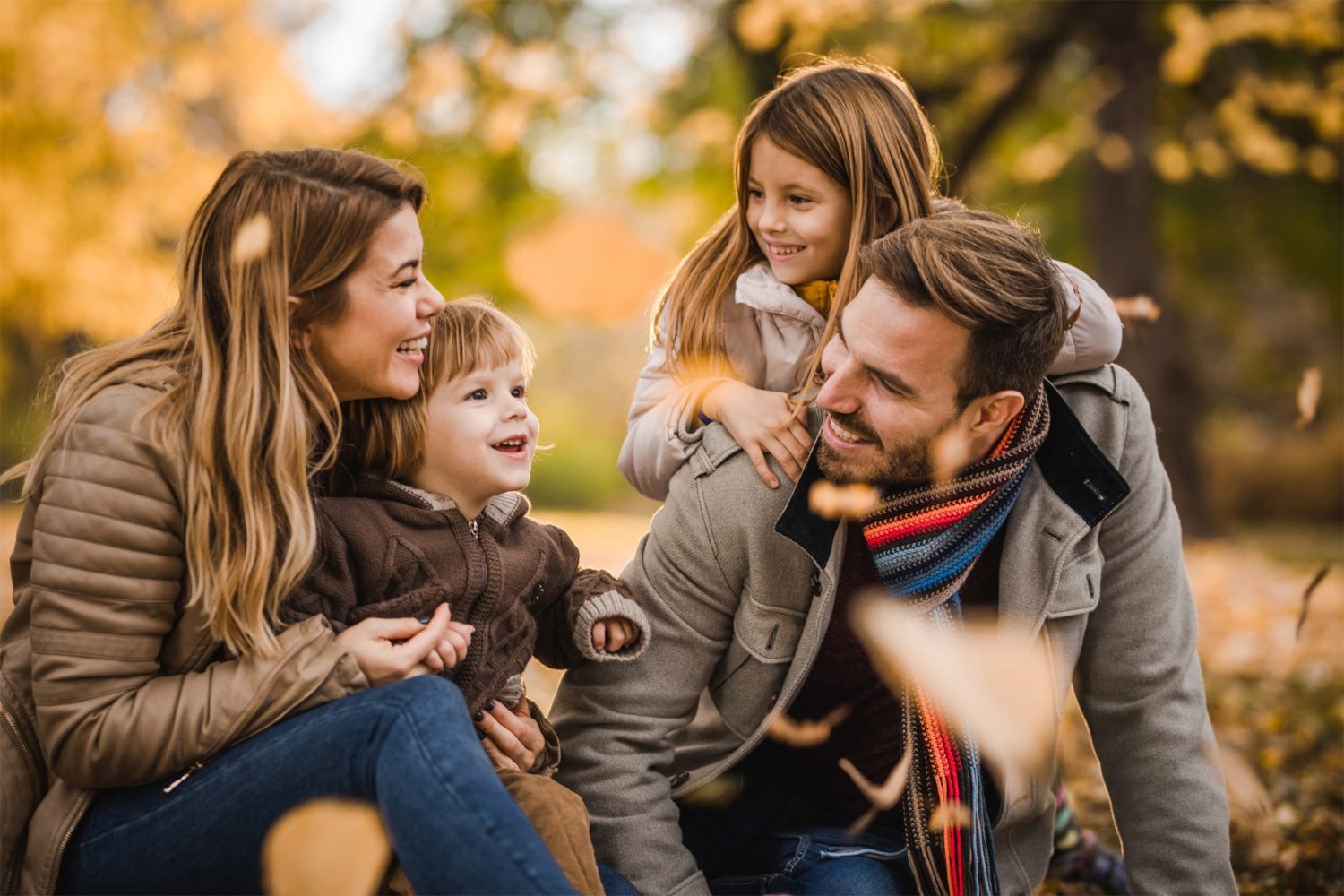 A family is relaxing at a Kinderhotel in the park during fall.