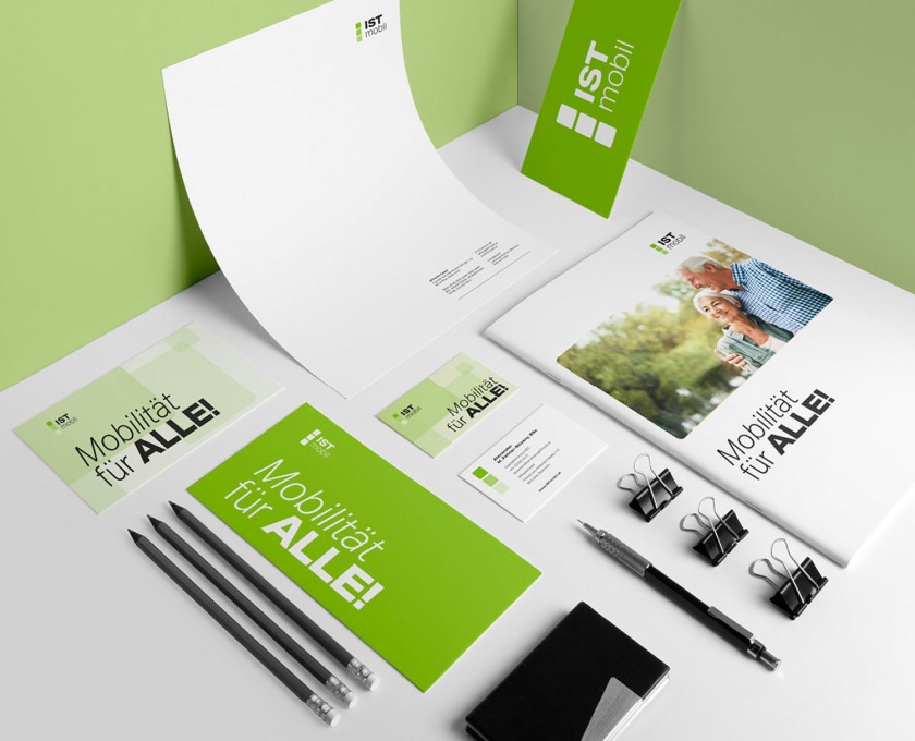 A green business stationery set on a table, featuring ISTmobil branding.