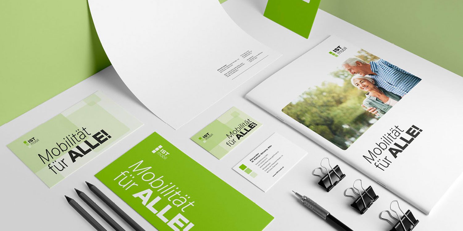 A green business stationery set on a table, featuring ISTmobil branding.