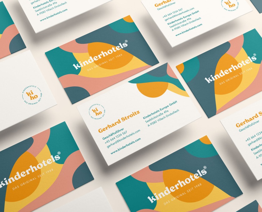 A set of Kinderhotels business cards with colorful designs.