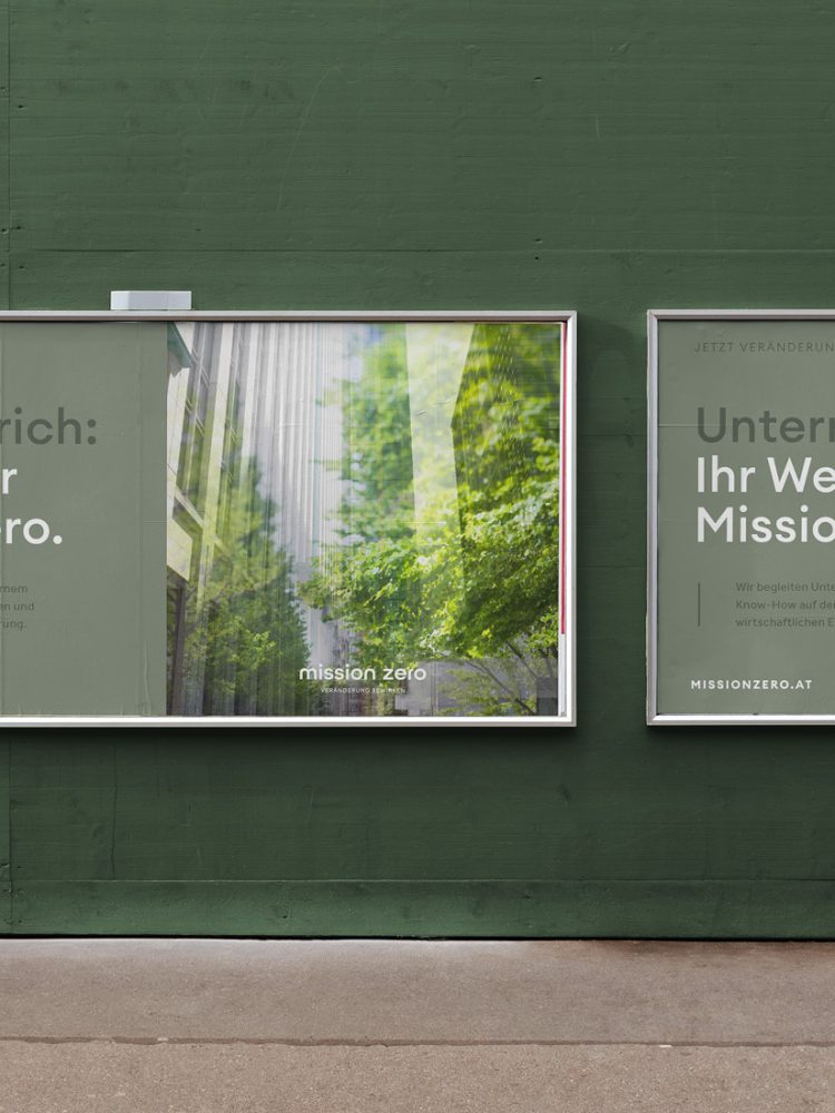 Two billboards promoting Mission Zero on the side of a green wall.