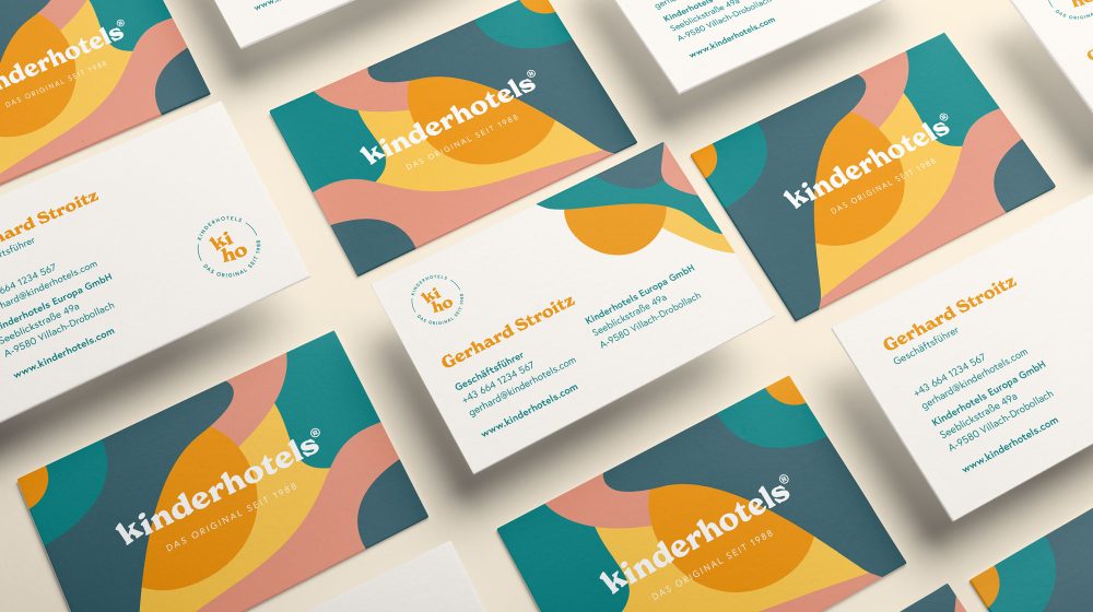 A set of Kinderhotels business cards with different shapes and colors.