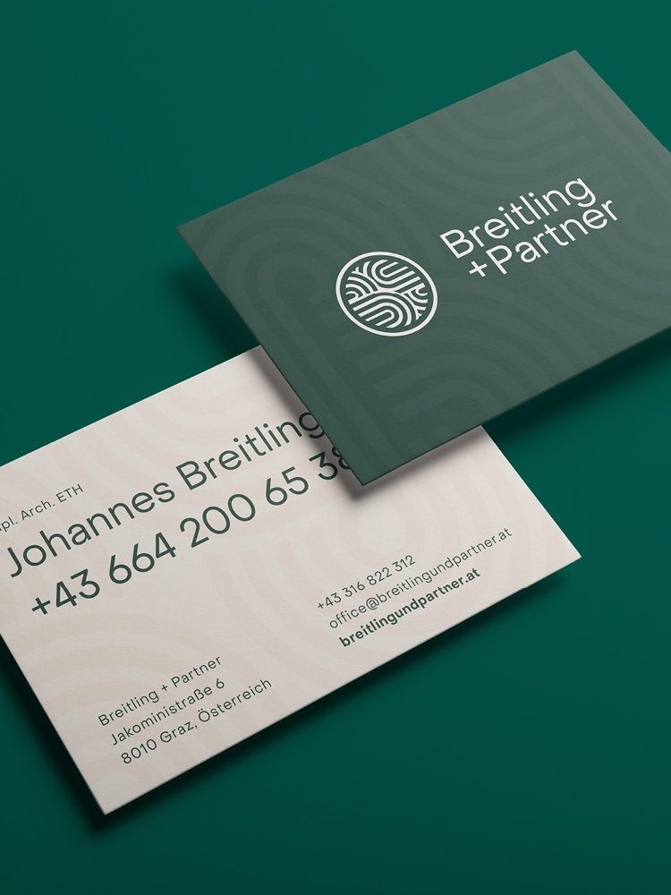 A green and white business card featuring Breitling+Partner on a green background.